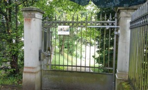 Cierrapuertas en verja exterior de acceso a cementerio